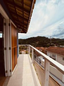 a balcony of a house with a view at Suite Lavanda in Santo Antônio do Pinhal
