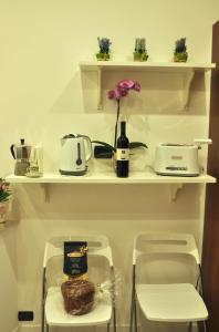 a shelf with a bottle of wine and a flower on it at The Avalon in Rome