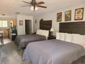 a bedroom with two beds and a ceiling fan at Lumbermen's Village in Pinetop-Lakeside