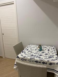 a table and chairs with a tablecloth on a table at Casa Vacanze Antares in Scilla