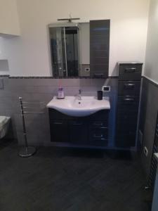 a bathroom with a sink and a mirror at Monti di bò in Aggius +19 photos