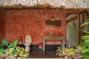 a bathroom with a toilet and a sink at Casa Chapolin Boutique Guesthouse in Palomino +37 photos