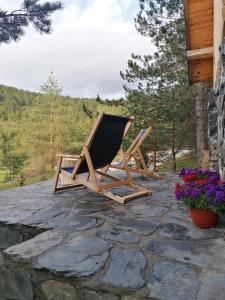 a wooden lounge chair sitting on a stone patio at Garac Zlatibor Vikendica in Zlatibor