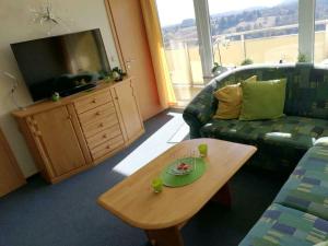 a living room with a couch and a coffee table at Gipfelzauber in Braunlage