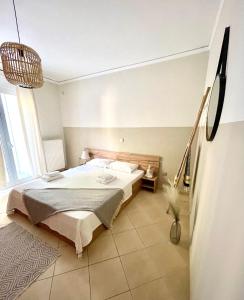 a bedroom with a bed and a large window at Bocca house near Athens Airport in Spata