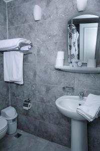 a bathroom with a sink and a mirror and a toilet at Hali Hotel in Istanbul +37 photos