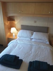 a bedroom with a bed with two pillows on it at Annandale skegness in Skegness