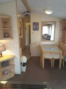 a small kitchen with a table and a dining room at Annandale skegness in Skegness