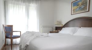 Posteľ alebo postele v izbe v ubytovaní Balneario Caldas de Luna