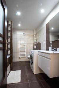 a bathroom with a washing machine and a sink at Apartman MANDALA in Banská Bystrica