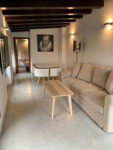 a living room with a couch and a table at Plaza Negrito Apartments in Valencia