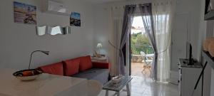 a living room with a red couch and a table at APARTAMENTOS BINIFORCAT CB apto 52 IDEAL PLACE FOR HOLIDAY in Cala en Blanes