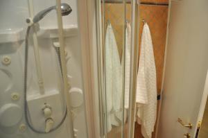 a shower with towels hanging in a bathroom at The Avalon in Rome