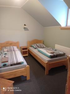 a bedroom with two beds and a window at Apartamenty w Karkonoszach in Lubawka