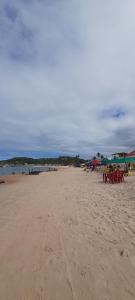 a beach with tables and chairs on the sand at Pousada Abais-Inn in Cabo de Santo Agostinho
