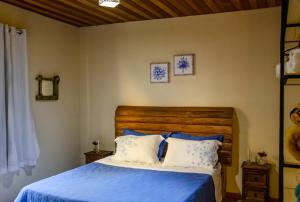 Una cama o camas en una habitación de Casa De Férias e Hospedagem Ana Lua