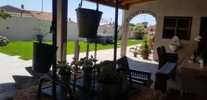 een terras met stoelen en potplanten op een veranda bij Rooms & Apartment STELIO in Loborika