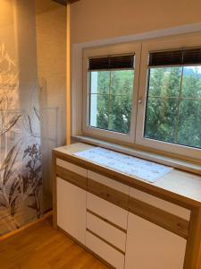 a kitchen with two windows and a white counter top at Ferienwohnung Tirol in Landeck