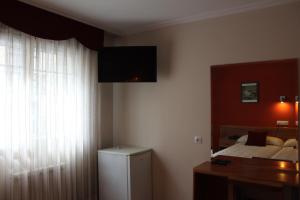 En eller flere senger på et rom på Hotel Rego Foz