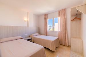 En eller flere senger på et rom på Apartamentos Avenida - MC Apartamentos Ibiza