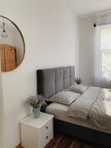 a bedroom with a bed with a mirror and a table at Luxurious 68m2 2BR 3-Room River View Apt in the heart of Pärnu in Pärnu