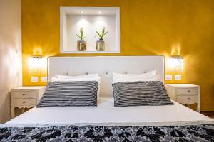 a hotel room with a white bed and white walls at Boutique Hotel La Casa di Morfeo in Florence