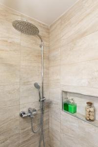 a shower with a shower head in a bathroom at Apartments Krmek in Dubrovnik