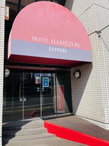 a red awning over a hotel hamilton sapporo at Hotel Hamilton Sapporo in Sapporo