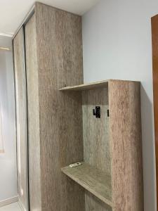 a bathroom with a shower with a wooden wall at Caldas Novas Aldeia do Lago in Caldas Novas