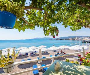 a view of a beach with umbrellas and the ocean at Haraki Beach Mediterranean Retreat in Haraki