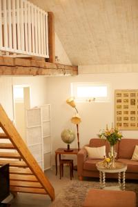 a living room with a couch and a table at Blomstertantens Hus in Trelleborg