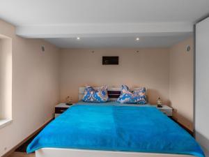 a bedroom with a blue bed with two pillows at Holiday home near the Oberhof ski resort in Kurort Steinbach-Hallenberg