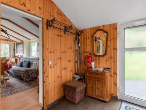 a room with a wooden wall with a mirror at Holiday home near the Oberhof ski resort in Kurort Steinbach-Hallenberg