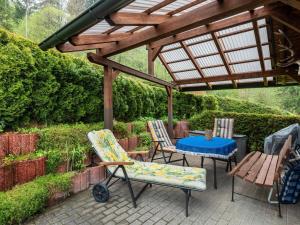 a patio with chairs and a table under a pergola at Holiday home near the Oberhof ski resort in Kurort Steinbach-Hallenberg