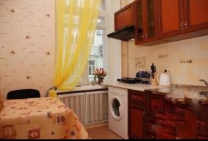 a kitchen with a washing machine and a window at Amazing view of St. Michael’s square in Kyiv