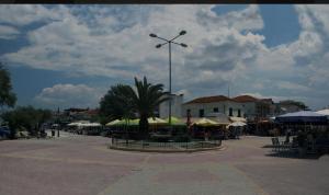 a plaza with a palm tree and a street light at Dimitris Flat in Neoi Epivates