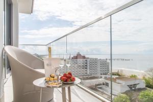 a table with a bowl of fruit on top of a balcony at Balticus Sea View in Międzyzdroje