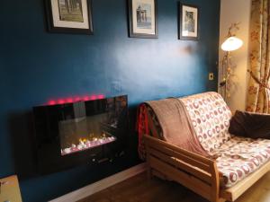 a living room with a couch and a fireplace at Lissadell Holiday Apartment in Buncrana