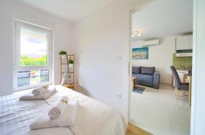 Postel nebo postele na pokoji v ubytování Dodo Apartments