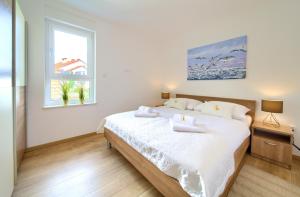 Postel nebo postele na pokoji v ubytování Dodo Apartments