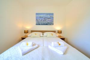 Postel nebo postele na pokoji v ubytování Dodo Apartments