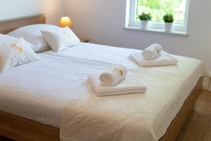 Postel nebo postele na pokoji v ubytování Dodo Apartments