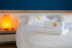 Postel nebo postele na pokoji v ubytování Dodo Apartments
