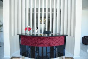 a table in a room with a wall of radiator at Fjortes Palace in Vlorë