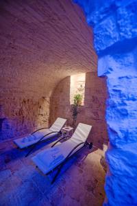 a group of lounging chairs in a tunnel at Petra Suite in Alberobello