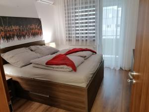 a bed with a red blanket on it in a bedroom at Foreta in Bratislava