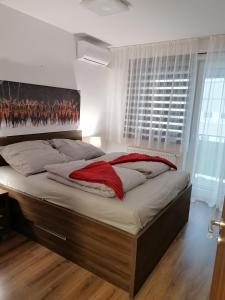 a bedroom with a large bed with a painting on the wall at Foreta in Bratislava
