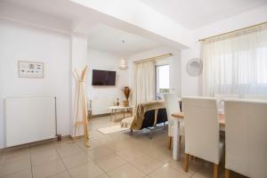 a living room with a table and a dining room at La Casa Del Amor in Kalithies