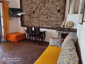 a living room with a couch and a table at B&B Il Padrino in Savoca