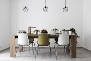a dining room table with four chairs around it at ReGenzio in Colledara